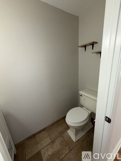 A room with a fireplace and a ceiling fan.