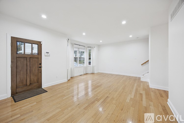 A room with wooden floors and a wooden door.