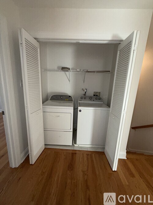 A small laundry room with a washer and dryer.