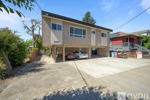 A two-story house with a garage and a driveway.