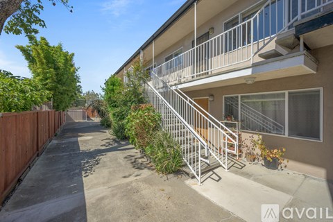 A house with a balcony and a staircase leading to it.