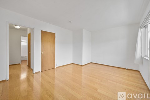 A room with wooden floors and white walls.