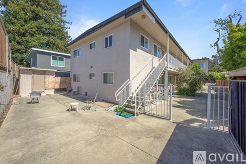 A house with a driveway and a metal gate.