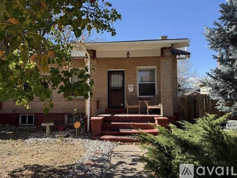 A house with a brown door and a porch with red steps.