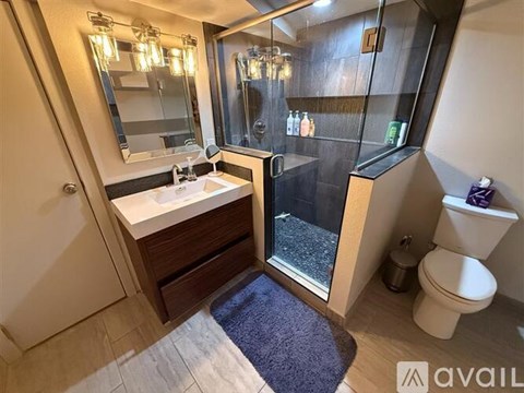 A bathroom with a sink, toilet, and shower.