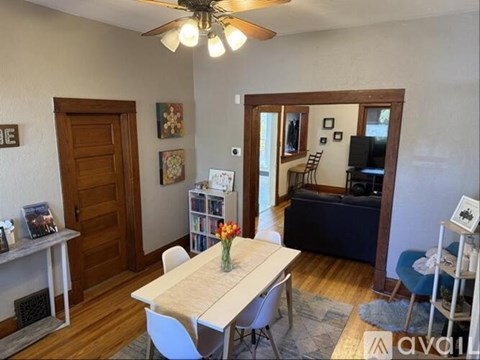 A living room with a dining table and chairs.