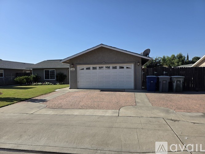 A house with a garage and driveway in front.