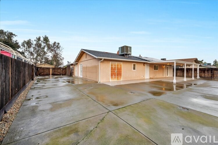 A house with a brown roof and a brown fence is available for rent.