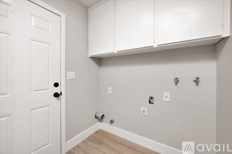 A white door is on the left and a white cabinet is on the right.