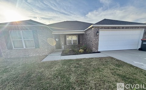 A house with a garage and a driveway is available for sale.