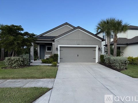 A house with a garage and a driveway is for sale.