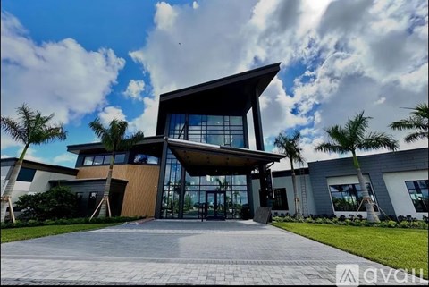 A modern house with a large glass entrance and a wooden exterior.