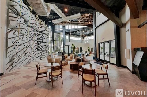 A modern dining area with wooden chairs and tables.
