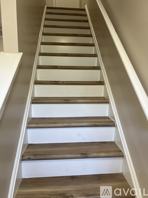 A set of stairs with wooden steps and white risers.