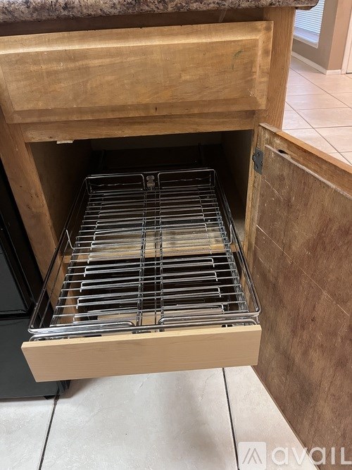 A drawer with a metal rack inside it.