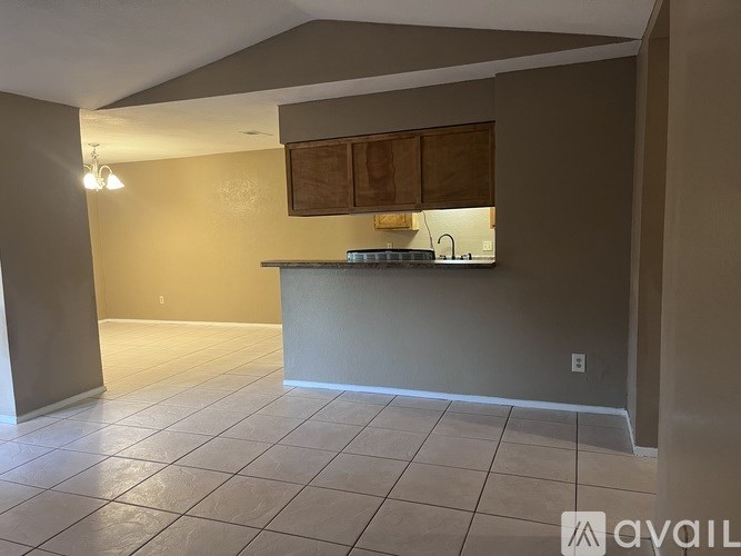 A kitchen area with a counter and cabinets.