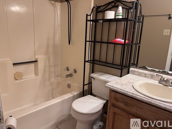 A bathroom with a toilet, sink, and bathtub.