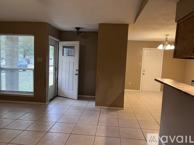 A kitchen area with a counter and cabinets.