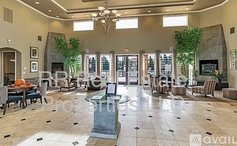 A spacious lobby with a fireplace and seating area.