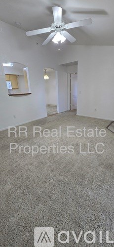 A room with a ceiling fan and a light fixture.