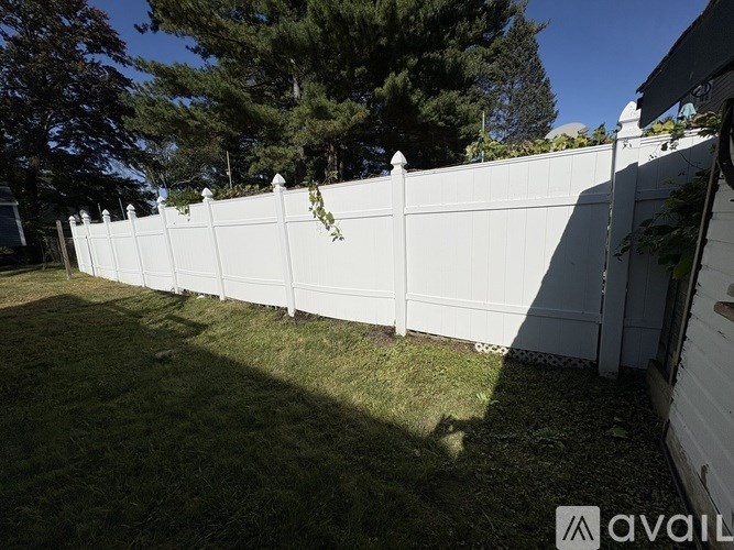 A white fence with vines growing on it.