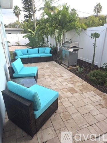 A patio with a couch and chairs.