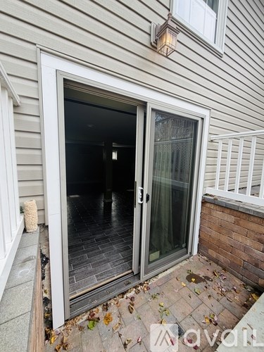 A glass door is open to a dark interior.