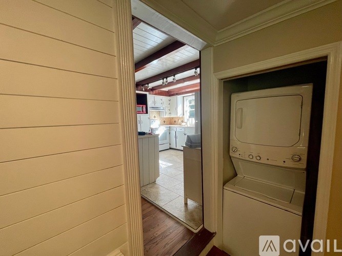 A white washing machine is in a small room.