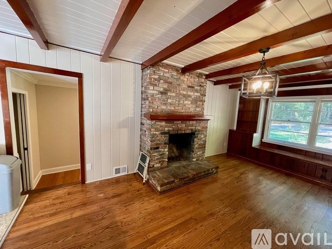 A room with a fireplace and wooden floors.