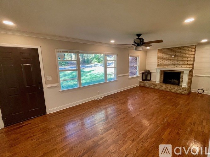 A room with wooden floors and a fireplace.