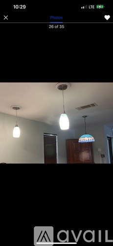 A house with a fence and trees in front of it.