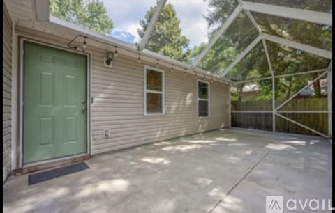 A house with a green door and a glass roof extension.