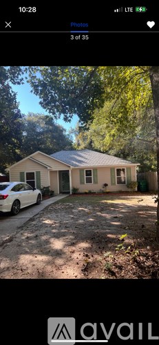 A house with a car parked in front of it.