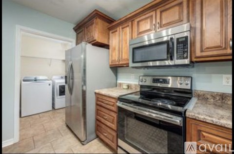 A kitchen with wooden cabinets and stainless steel appliances.