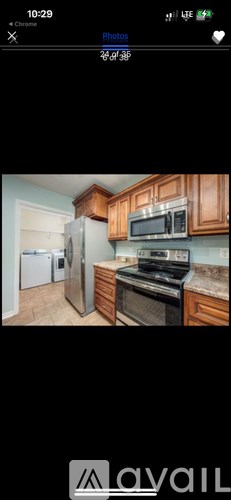 A spacious room with wood flooring and a ceiling fan.