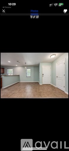 A bathroom with a wooden vanity and a mirror above it.