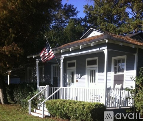 A house with a flag on the front porch.