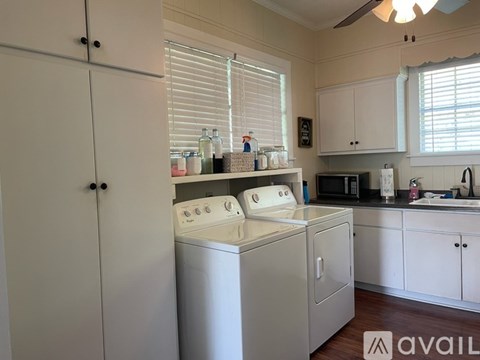 A white kitchen with a washer and dryer built in.