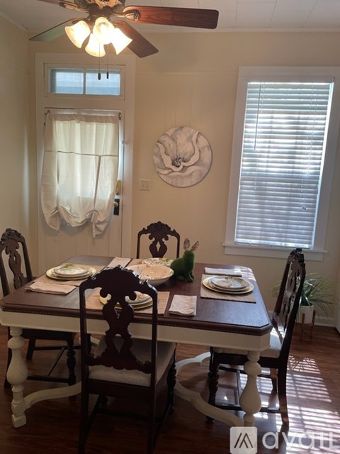 A dining room with a table set for two.