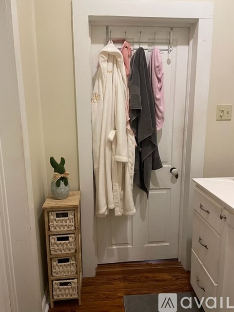 A white closet with a white door and a white cabinet.
