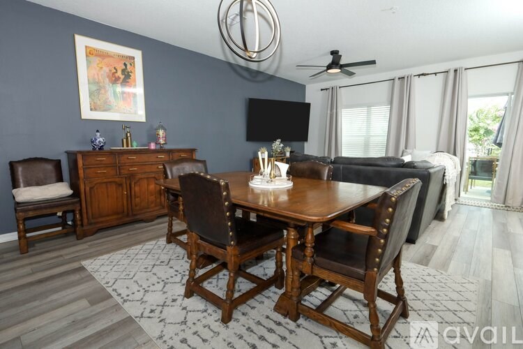 A dining room with a wooden table and chairs.