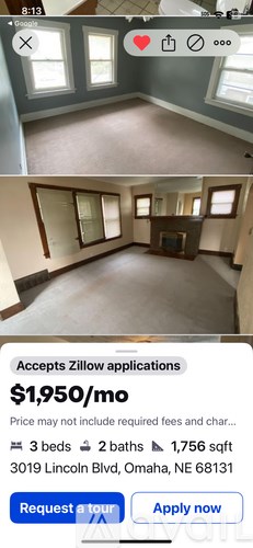 A room with a fireplace and a mirrored wall.