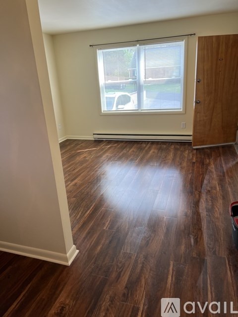 A room with wooden floors and a sliding glass door.