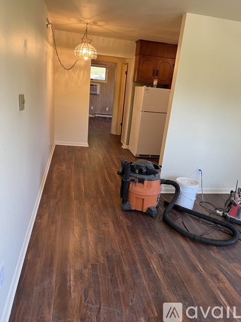 A room with wooden floors and a chandelier.