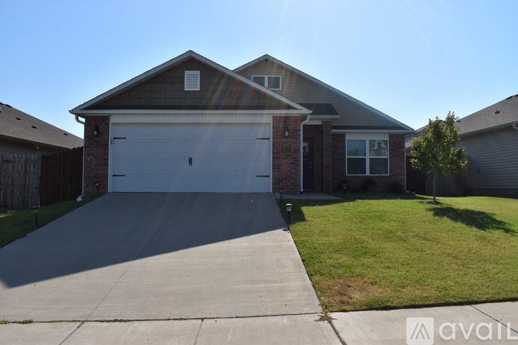 A house with a garage and a driveway in front.