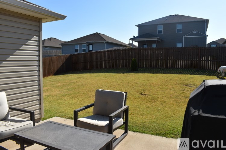 A backyard with a chair and table.