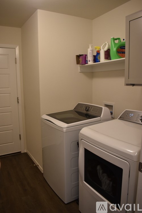 A small laundry room with a washer and dryer.