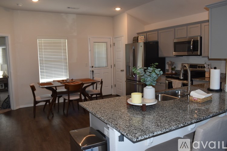 A kitchen with granite countertops and stainless steel appliances.