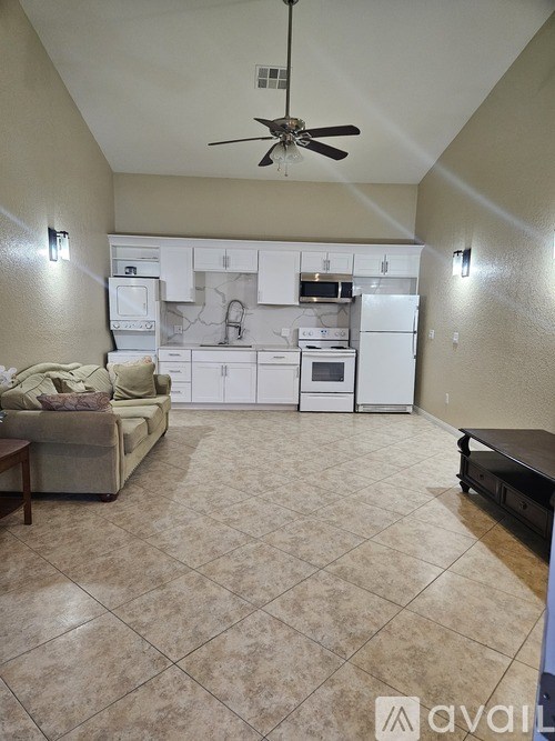 A patio with a table and chairs is visible through a doorway.
