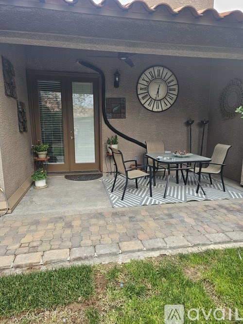 A bathroom with a sink, mirror, and brown cabinets.